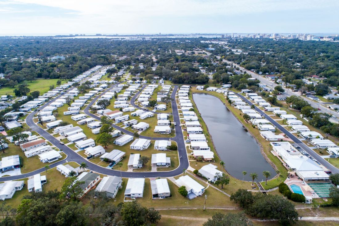 Aerial view of a palm-lined manufactured home community, used here for illustration